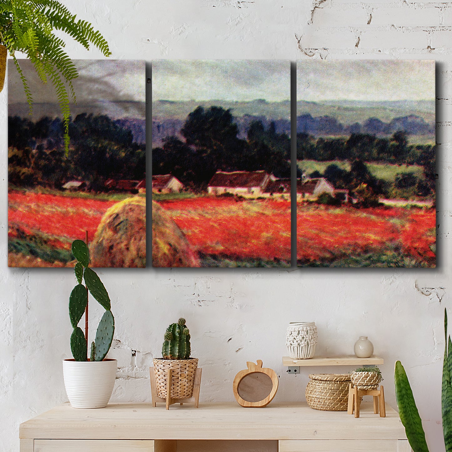 Three-panel canvas wall art featuring red poppy field near barn, displayed in a boho-chic entryway above a console table.