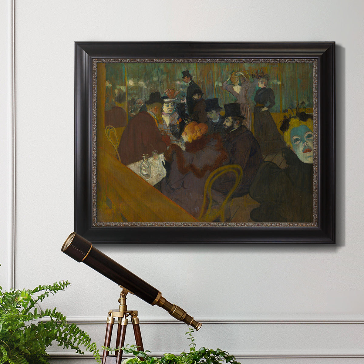 Impressionist cabaret interior scene by Henri de Toulouse-Lautrec in an ornate black frame with gilded inner detail displayed in a light-toned interior setting.