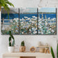 Three-panel canvas wall art featuring coastal garden overlooking bay, displayed in a boho-chic entryway above a console table.