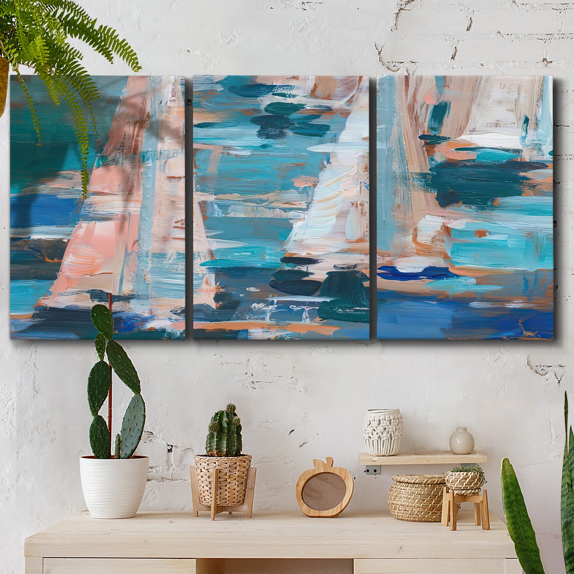 Three-panel canvas wall art featuring graphic pop style sailboats, displayed in a boho-chic entryway above a console table.
