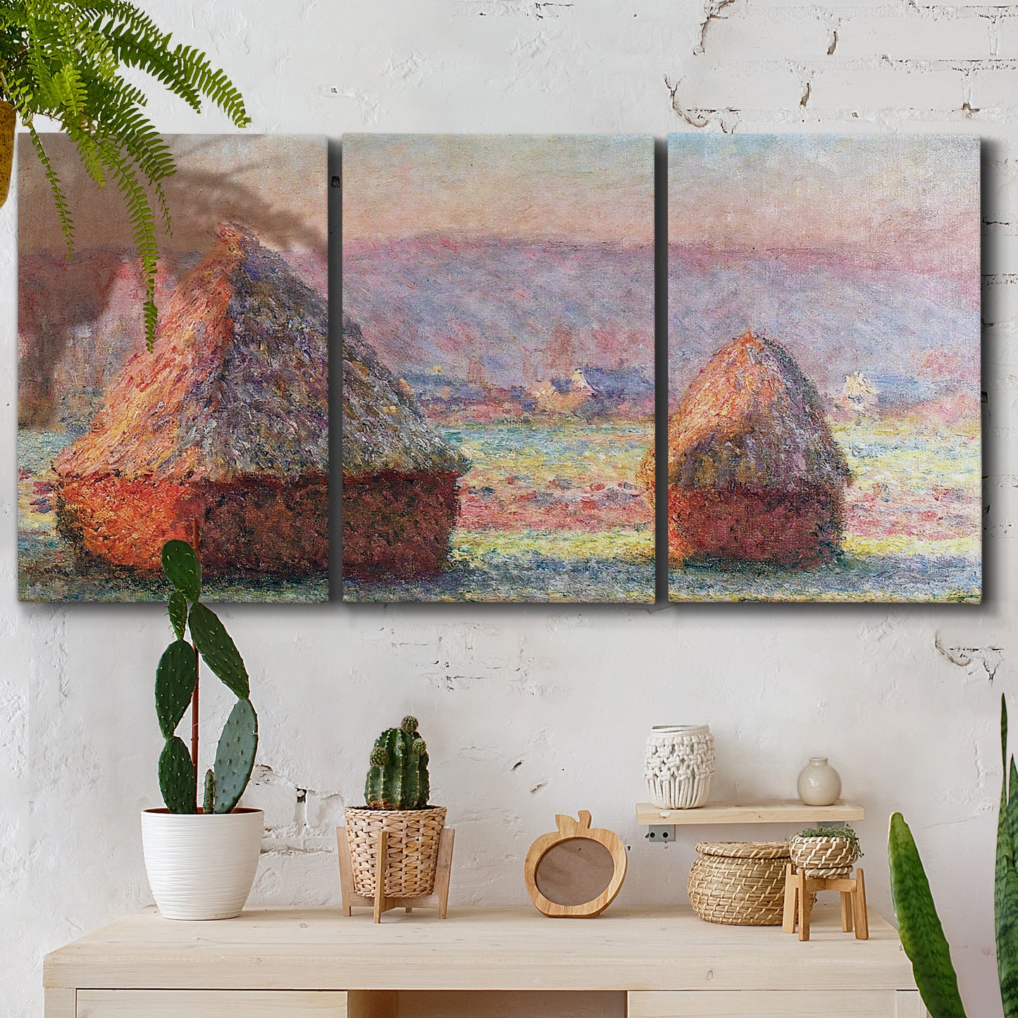 Three-panel canvas wall art featuring winter grainstacks glowing at sunset, displayed in a boho-chic entryway above a console table.