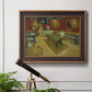 Impressionist interior of a night café by Vincent van Gogh in an ornate bronzed mahogany wood frame displayed in a light-toned interior setting.