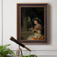Classical interior scene of a woman weaving flowers by Godfried Schalcken in an ornate bronzed mahogany wood frame displayed in a light-toned interior setting.