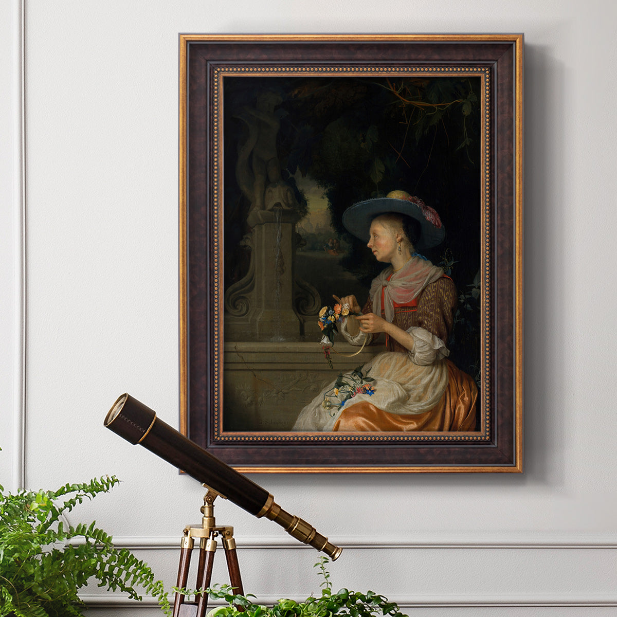 Classical interior scene of a woman weaving flowers by Godfried Schalcken in an ornate bronzed mahogany wood frame displayed in a light-toned interior setting.