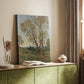 Canvas art print of a calm countryside scene with trees and gentle light styled in a home decor setting.