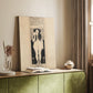Canvas art print of a stylized figure with decorative elements and strong vertical form styled in a home decor setting.