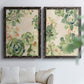 Set of two black barnwood framed canvas prints depicting green rosettes, peach blossoms, and mosaic-like outlines arranged across two complementary compositions above a sofa in a bright living space.