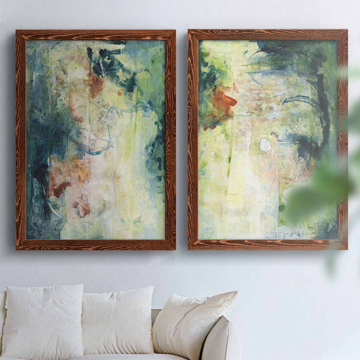 Set of two maple barnwood framed canvas prints depicting vertical organic marks, pale light passages, and weathered surfaces arranged across two complementary compositions above a sofa in a bright living space.