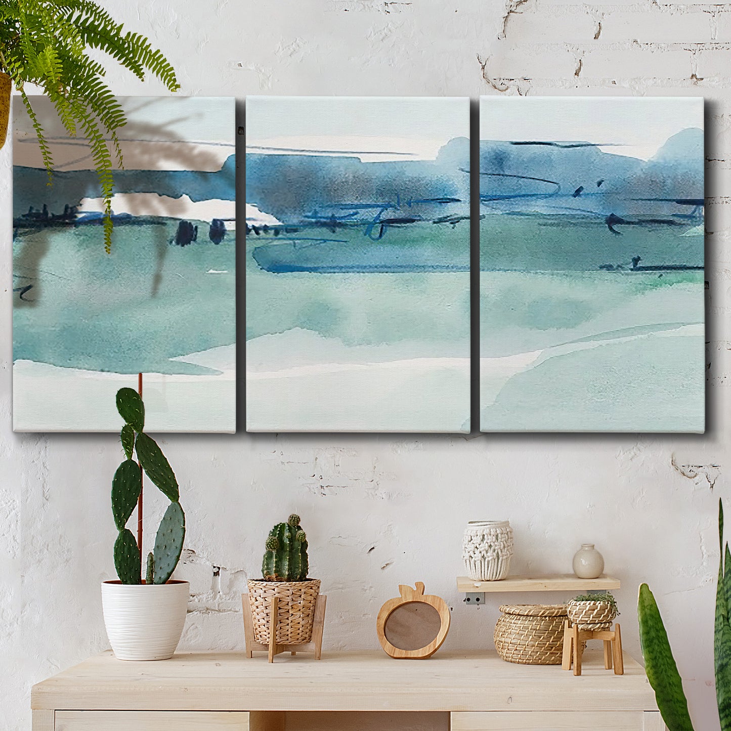 Three-panel canvas wall art featuring minimalist ultramarine abstract vista, displayed in a boho-chic entryway above a console table.