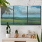 Three-panel canvas wall art featuring wide valley landscape with rolling hills, displayed in a boho-chic entryway above a console table.