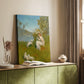 Canvas art print of a female figure and lambs in a forest clearing with greenery and warm tones styled in a home decor setting.