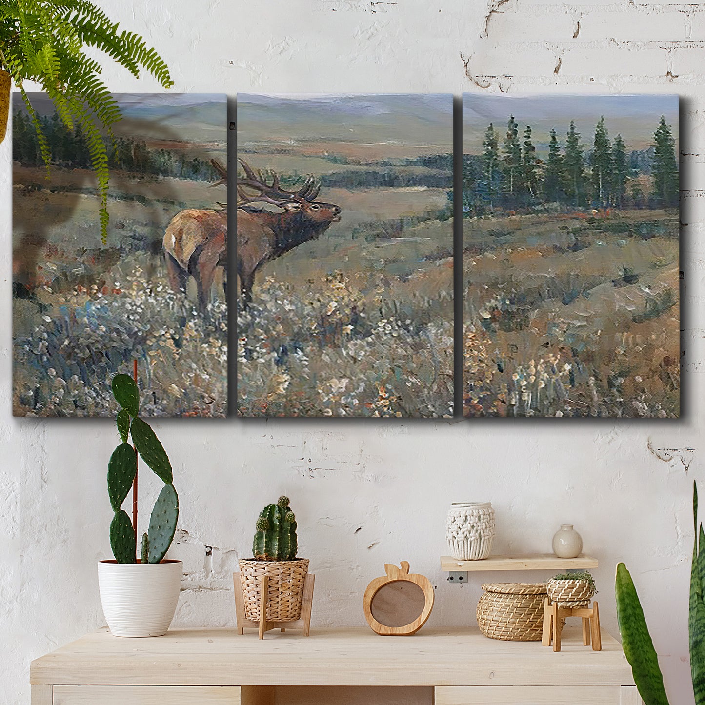 Three-panel canvas wall art featuring western wildlife grazing in open field, displayed in a boho-chic entryway above a console table.