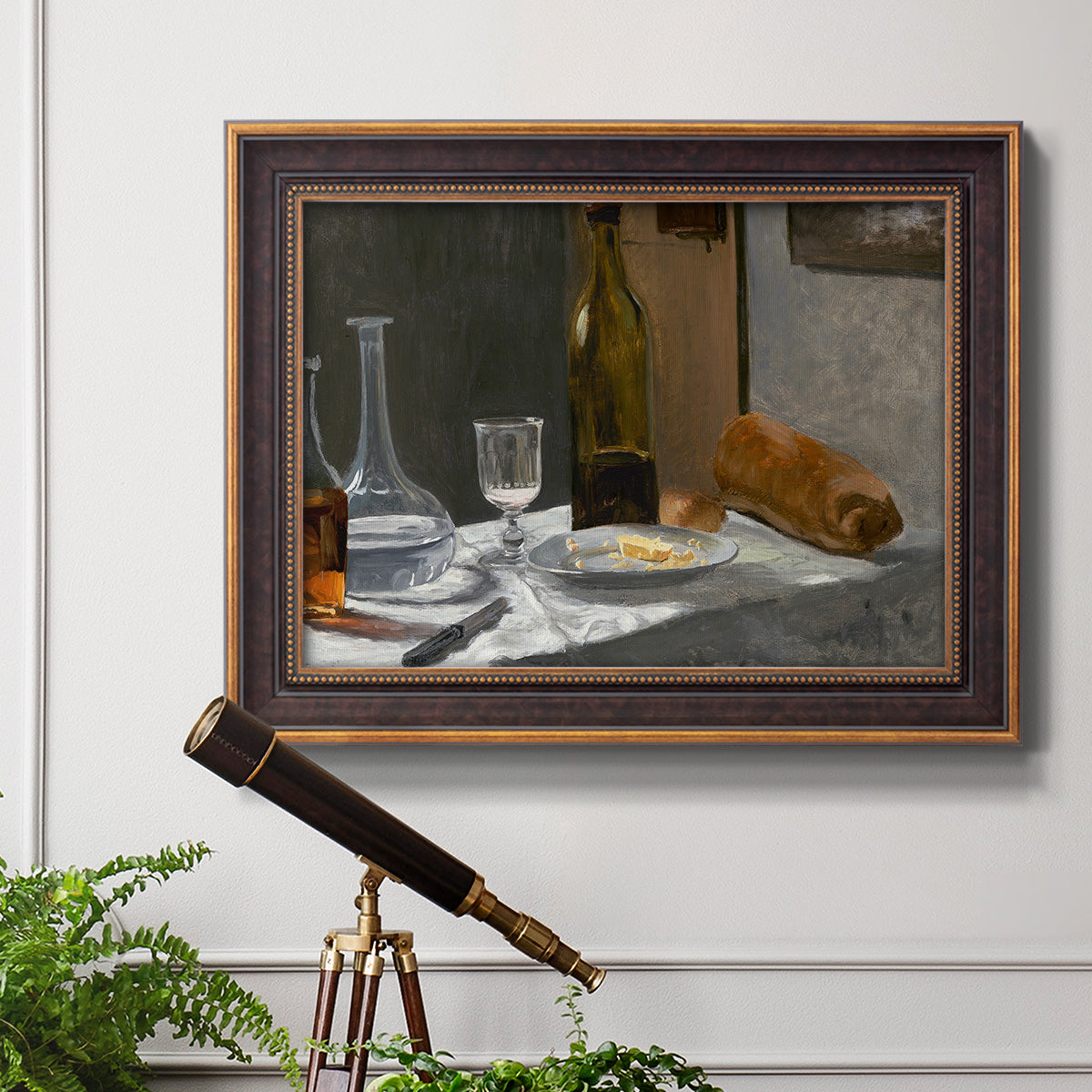 Impressionist still life with wine and bread by Claude Monet in an ornate bronzed mahogany wood frame displayed in a light-toned interior setting.