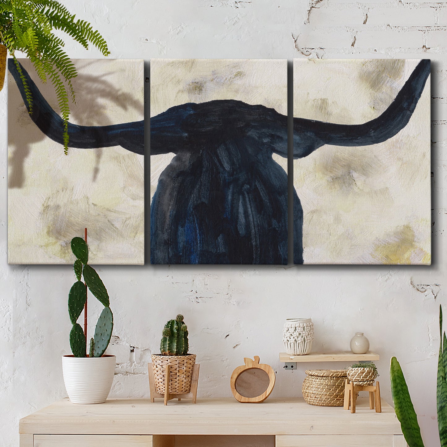 Three-panel canvas wall art featuring rustic animal portrait illustration, displayed in a boho-chic entryway above a console table.