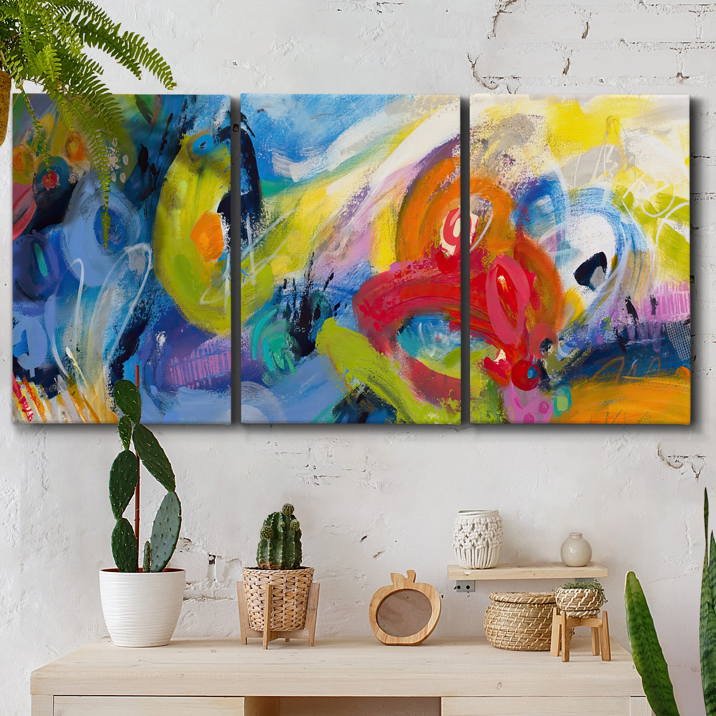 Three-panel canvas wall art featuring colorful abstract racing forms, displayed in a boho-chic entryway above a console table.