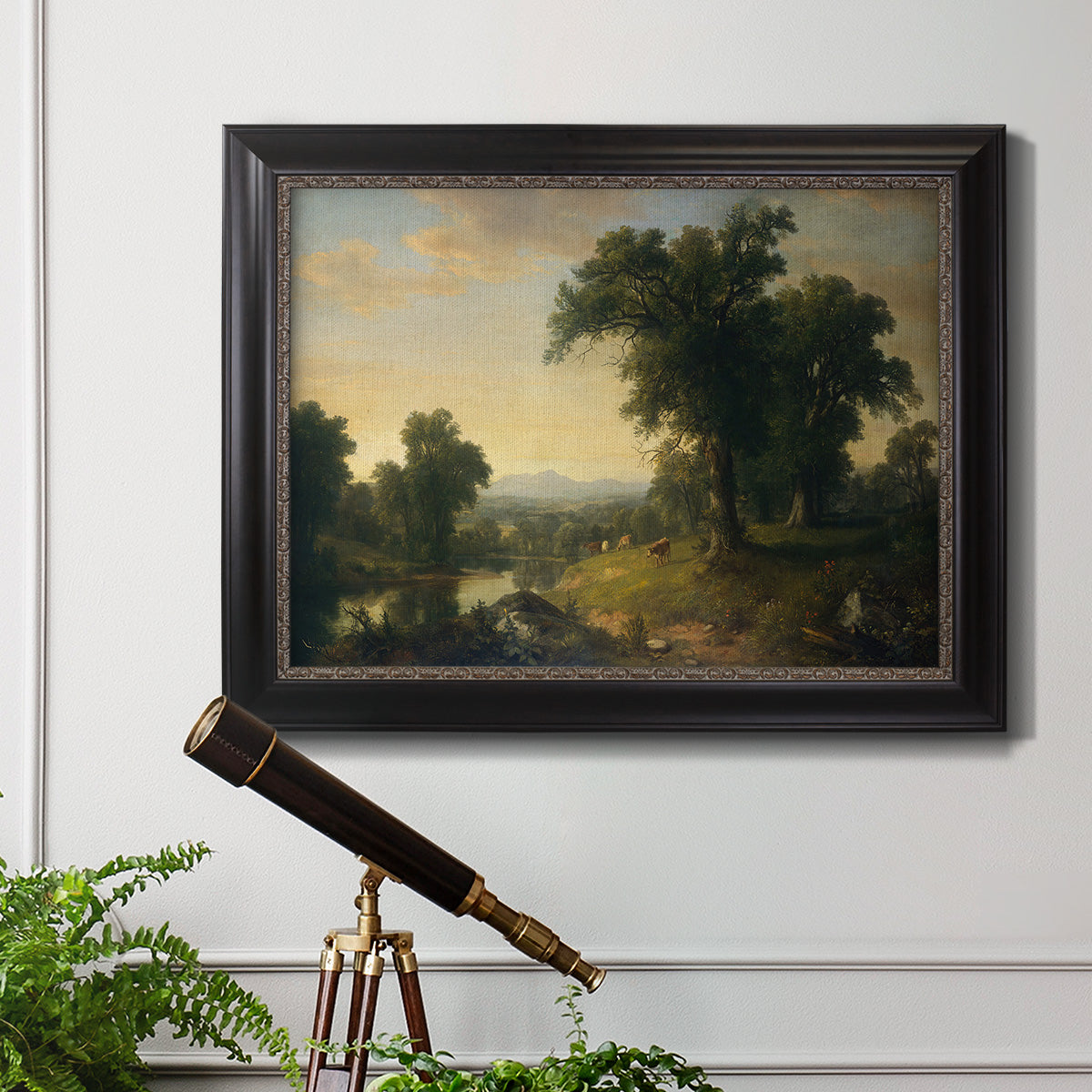 Traditional pastoral landscape painting by Asher Brown Durand in an ornate black frame with gilded inner detail displayed in a light-toned interior setting.