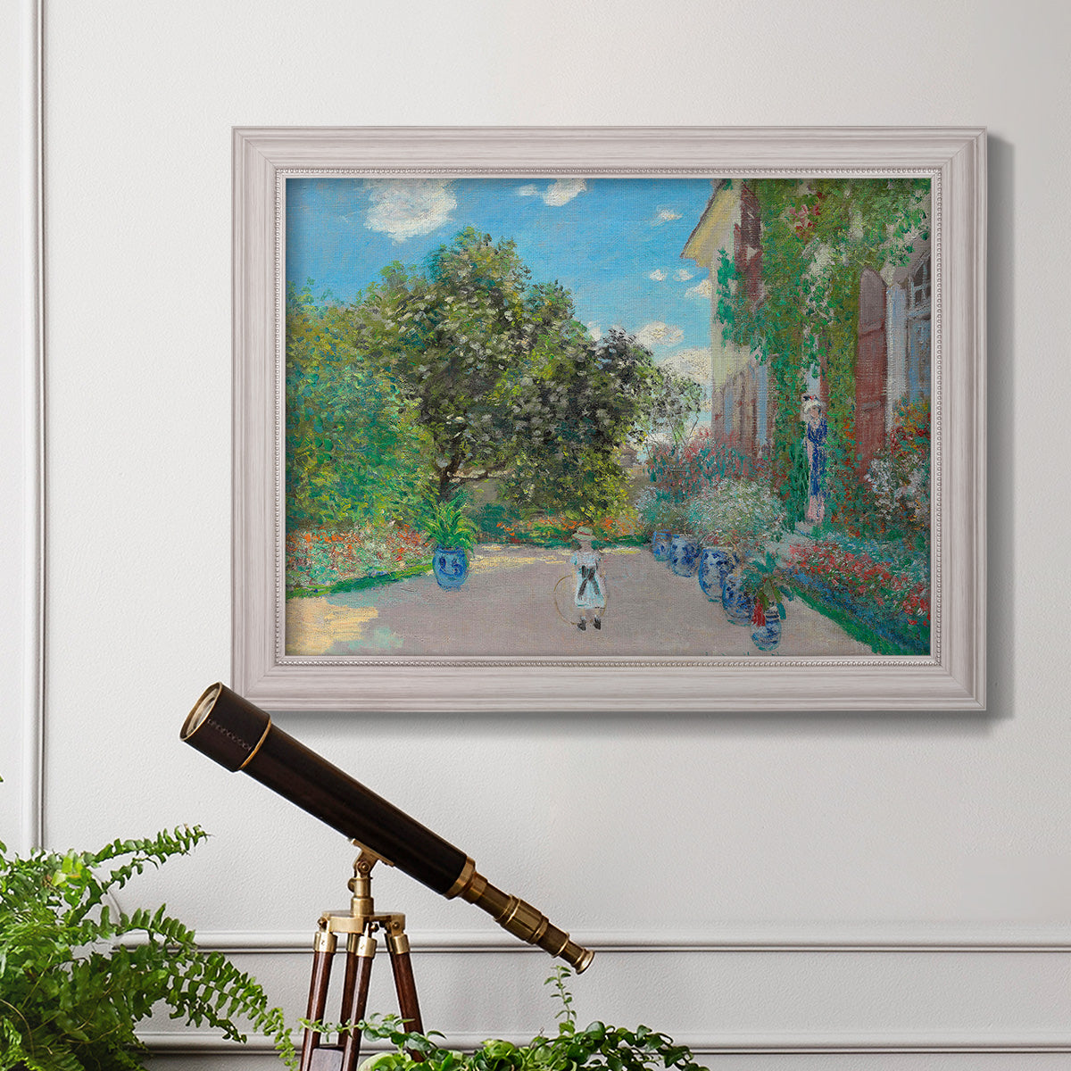 Impressionist residential landscape at Argenteuil by Claude Monet in an ornate weathered white frame displayed in a light-toned interior setting.