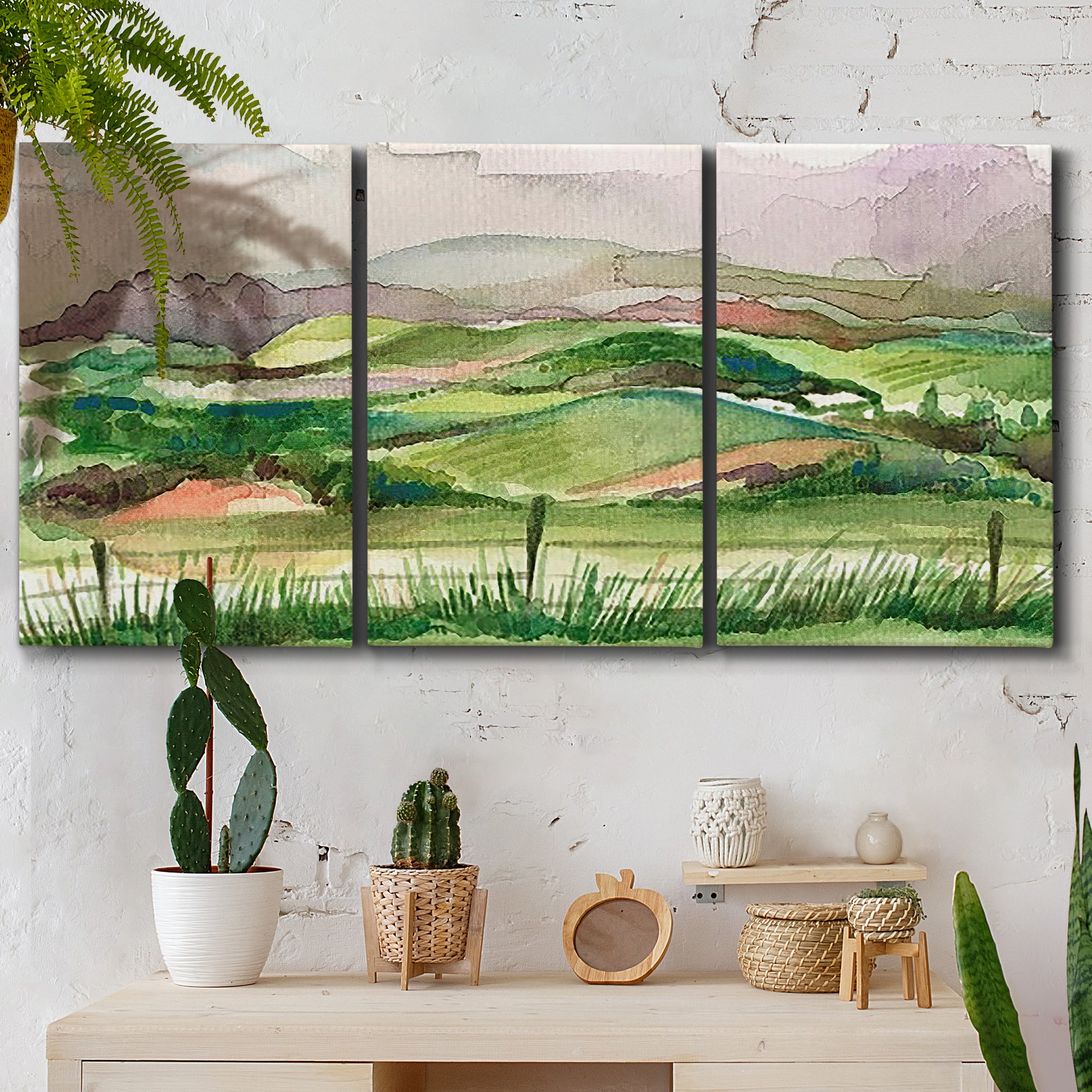Three-panel canvas wall art featuring rainy landscape with soft atmosphere, displayed in a boho-chic entryway above a console table.