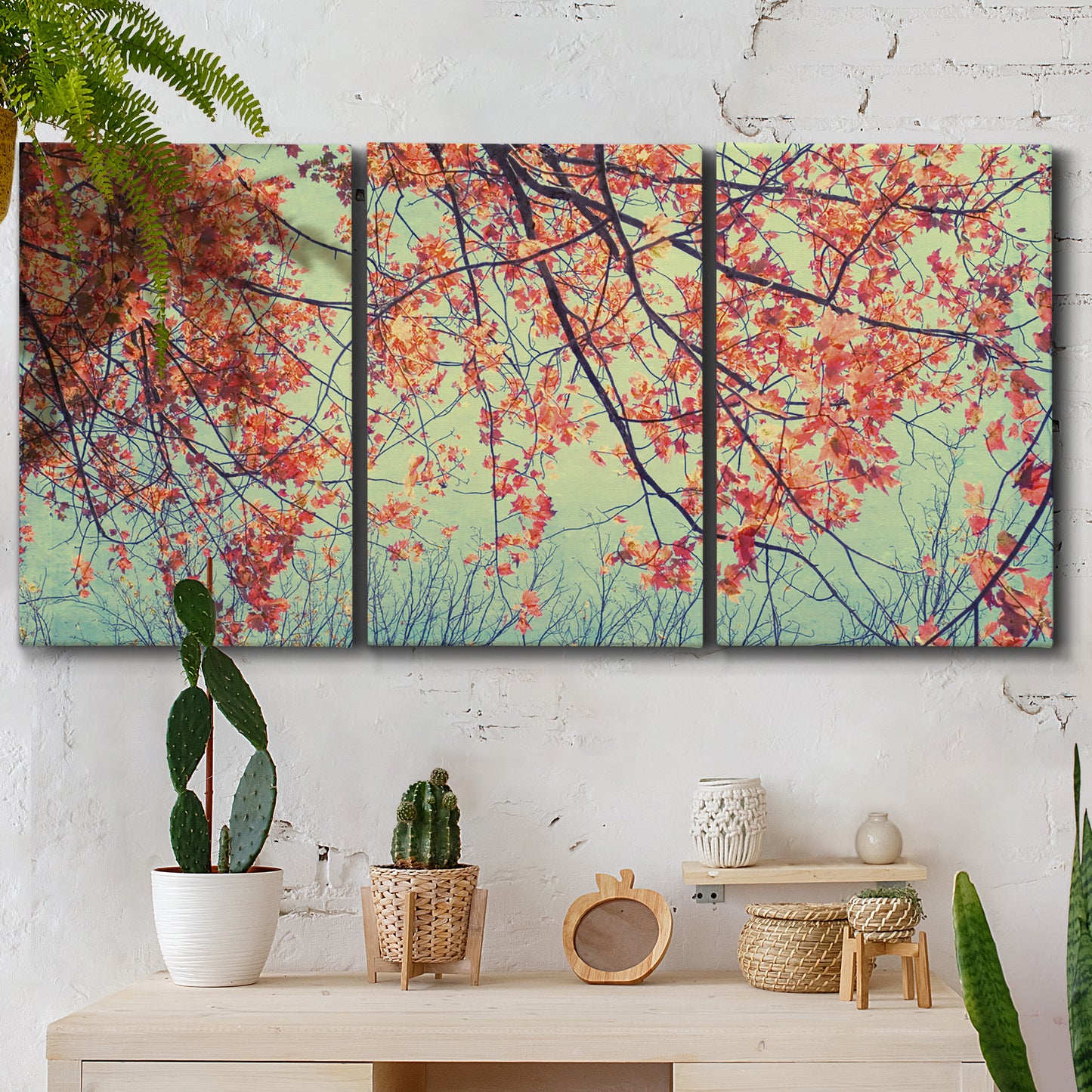 Three-panel canvas wall art featuring autumn foliage landscape photograph, displayed in a boho-chic entryway above a console table.