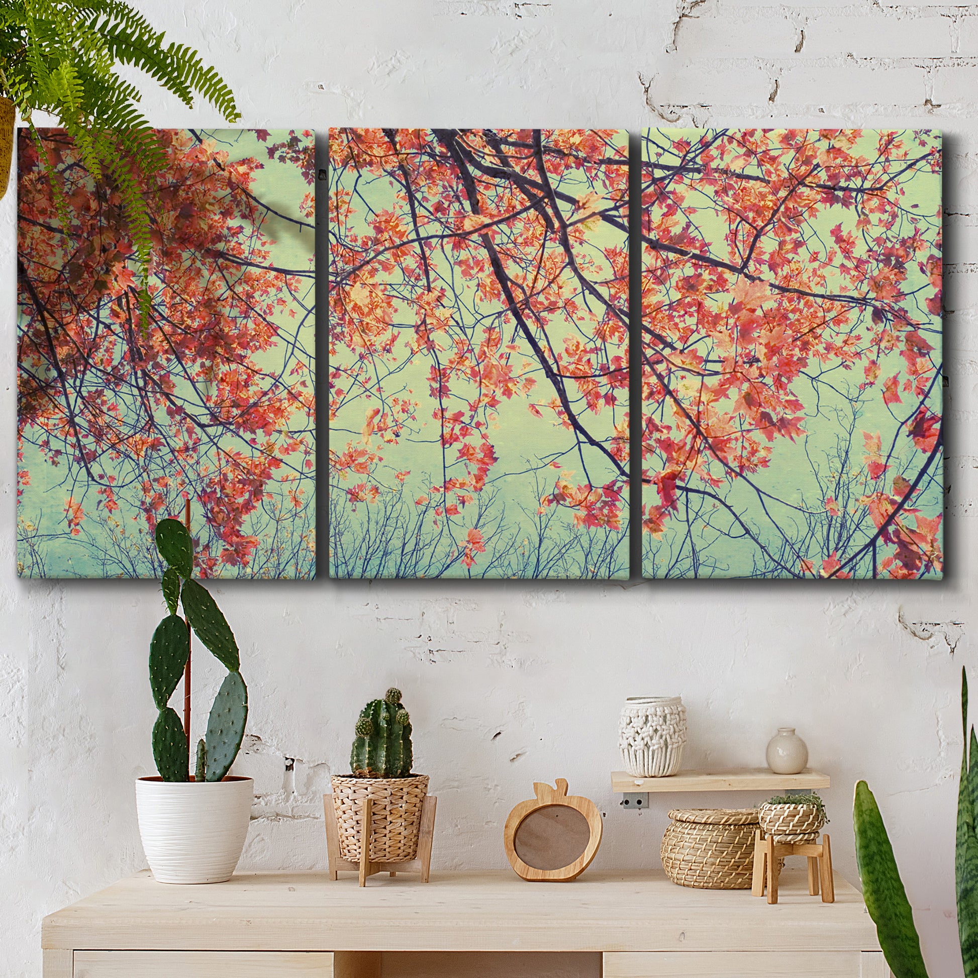 Three-panel canvas wall art featuring autumn foliage landscape photograph, displayed in a boho-chic entryway above a console table.
