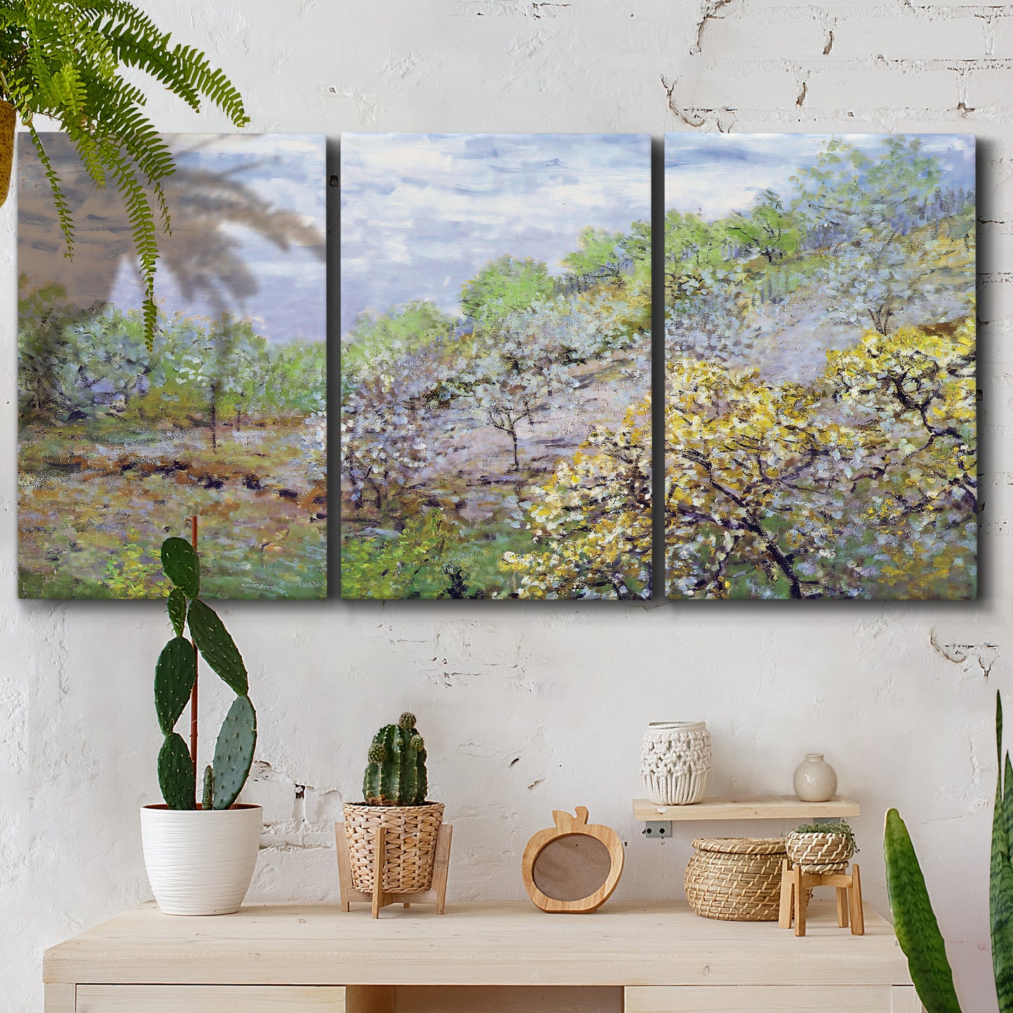 Three-panel canvas wall art featuring spring orchard in full bloom, displayed in a boho-chic entryway above a console table.