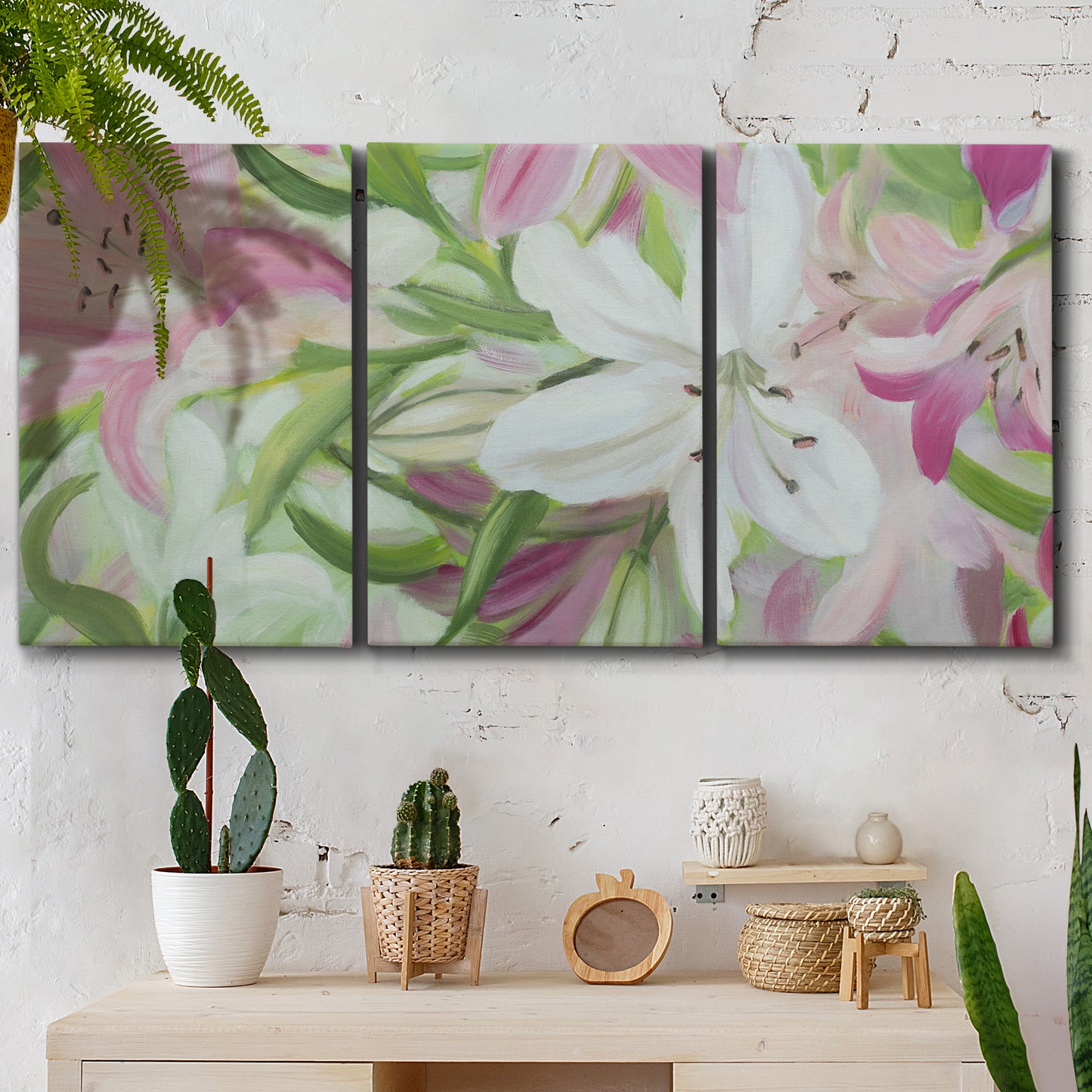 Three-panel canvas wall art featuring pink and white lilies botanical study, displayed in a boho-chic entryway above a console table.