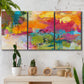 Three-panel canvas wall art featuring expressive abstract sunset tones, displayed in a boho-chic entryway above a console table.