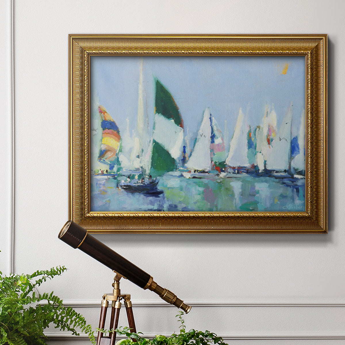 Coastal harbor watercolor painting in an ornate traditional gold frame displayed in a light-toned interior setting.