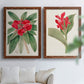 Set of two maple barnwood framed canvas prints depicting large green leaves, red blossoms, and archival cream paper arranged across two complementary compositions above a sofa in a bright living space.