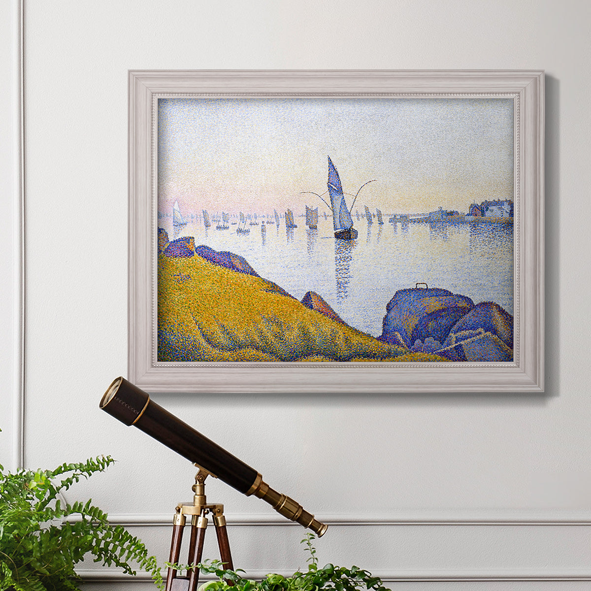 Impressionist coastal harbor at dusk by Paul Signac in an ornate weathered white frame displayed in a light-toned interior setting.