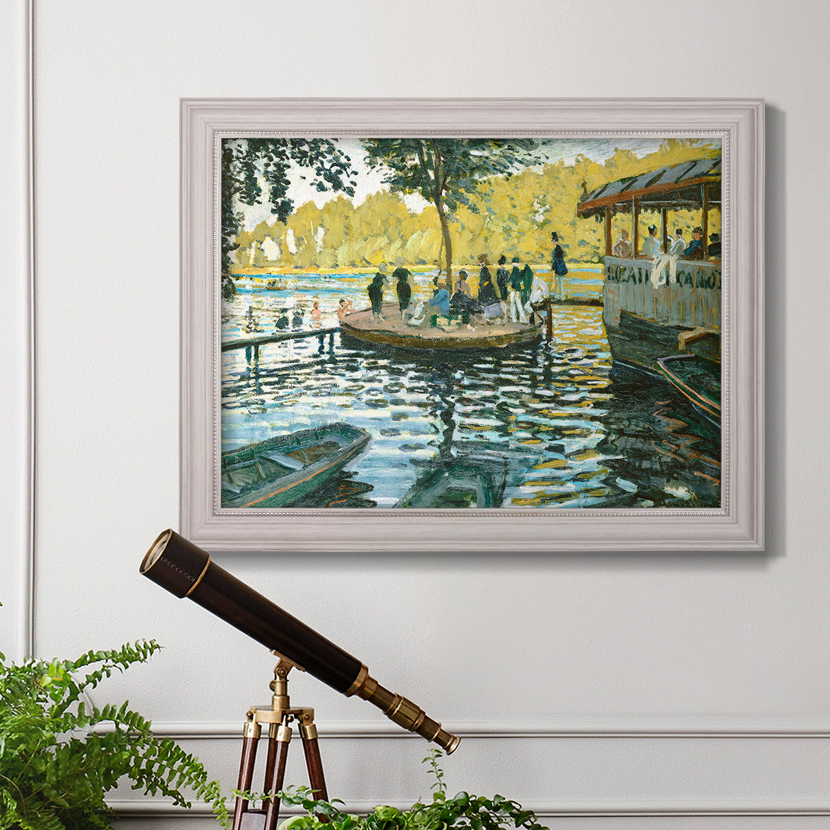Impressionist riverside leisure scene by Claude Monet in an ornate weathered white frame displayed in a light-toned interior setting.