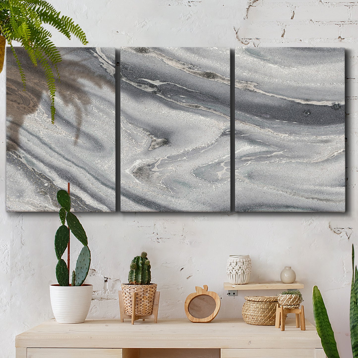 Three-panel canvas wall art featuring minimal monochrome abstract forms, displayed in a boho-chic entryway above a console table.