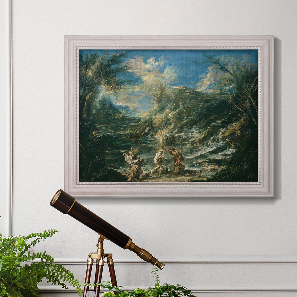 Religious landscape depicting the baptism of Christ by Alessandro Magnasco in an ornate weathered white frame displayed in a light-toned interior setting.