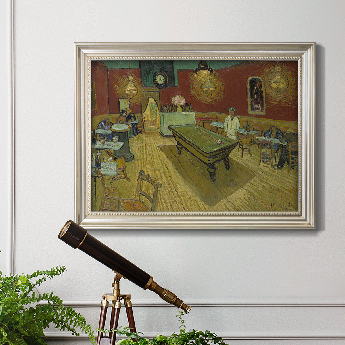 Impressionist interior of a night café by Vincent van Gogh in an ornate champagne frame displayed in a light-toned interior setting.