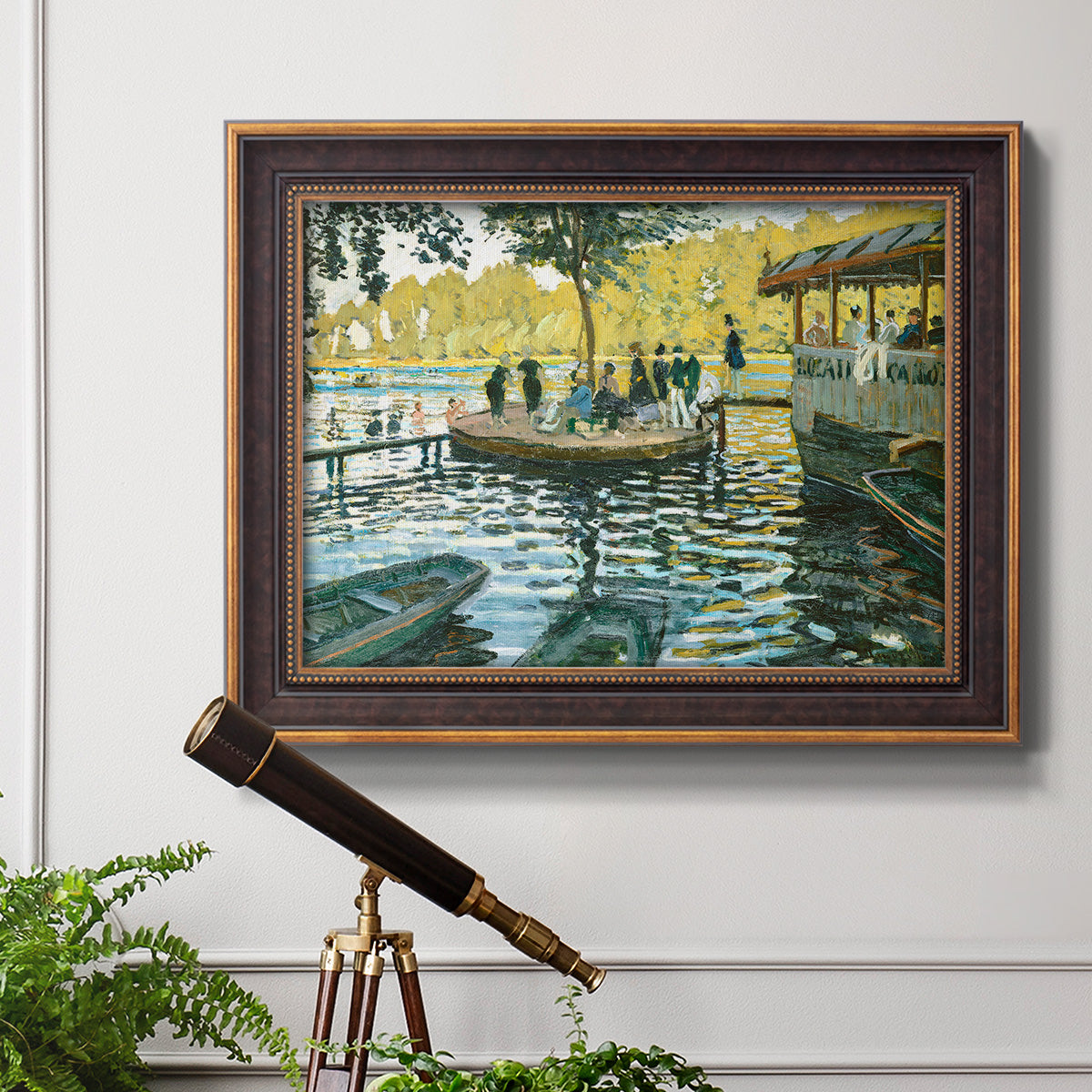 Impressionist riverside leisure scene by Claude Monet in an ornate bronzed mahogany wood frame displayed in a light-toned interior setting.