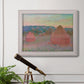 Impressionist haystack series landscape by Claude Monet in an ornate weathered white frame displayed in a light-toned interior setting.