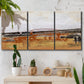 Three-panel canvas wall art featuring abstract bridge landscape in ochre, displayed in a boho-chic entryway above a console table.