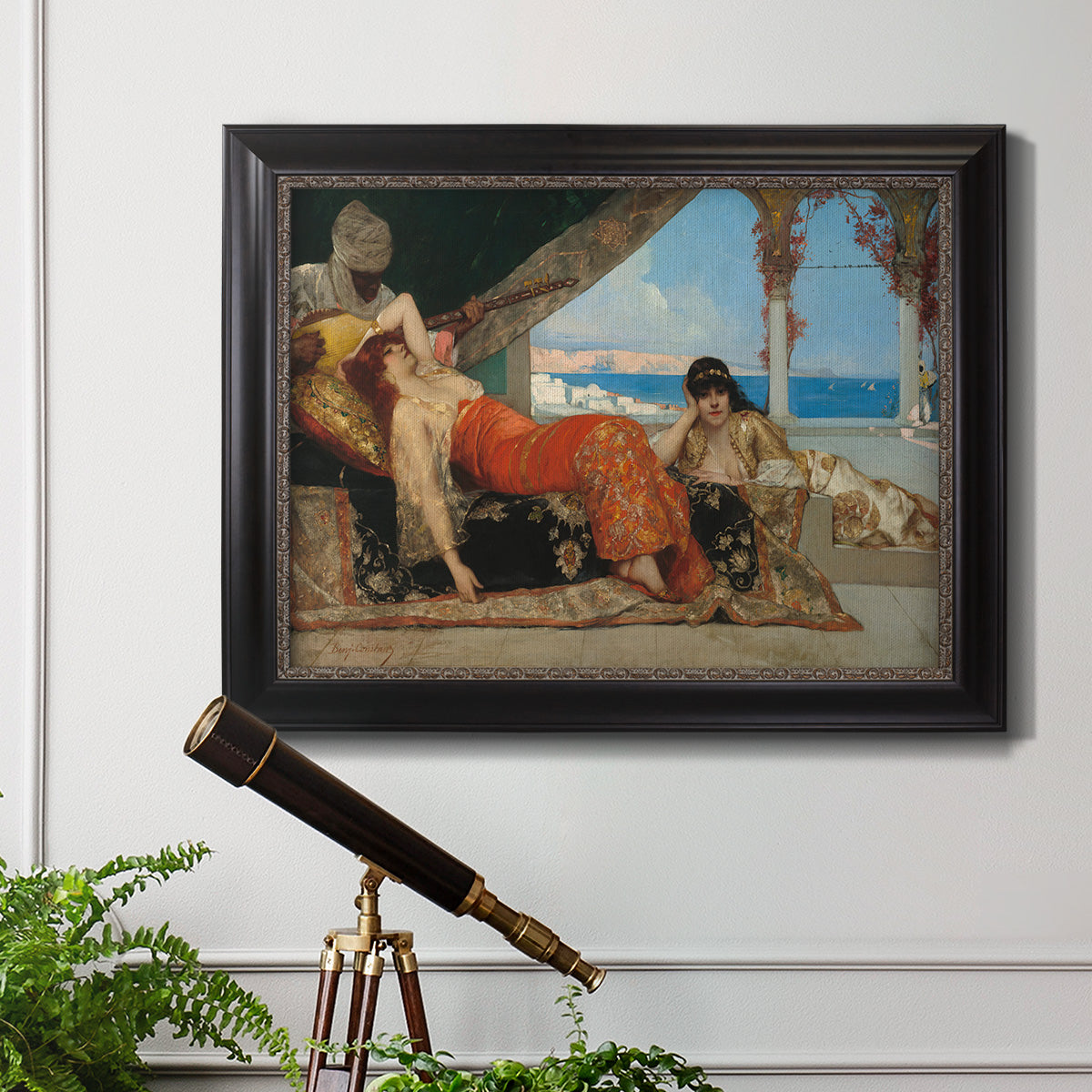 Orientalist portrait scene by Jean-Joseph Benjamin-Constant in an ornate black frame with gilded inner detail displayed in a light-toned interior setting.
