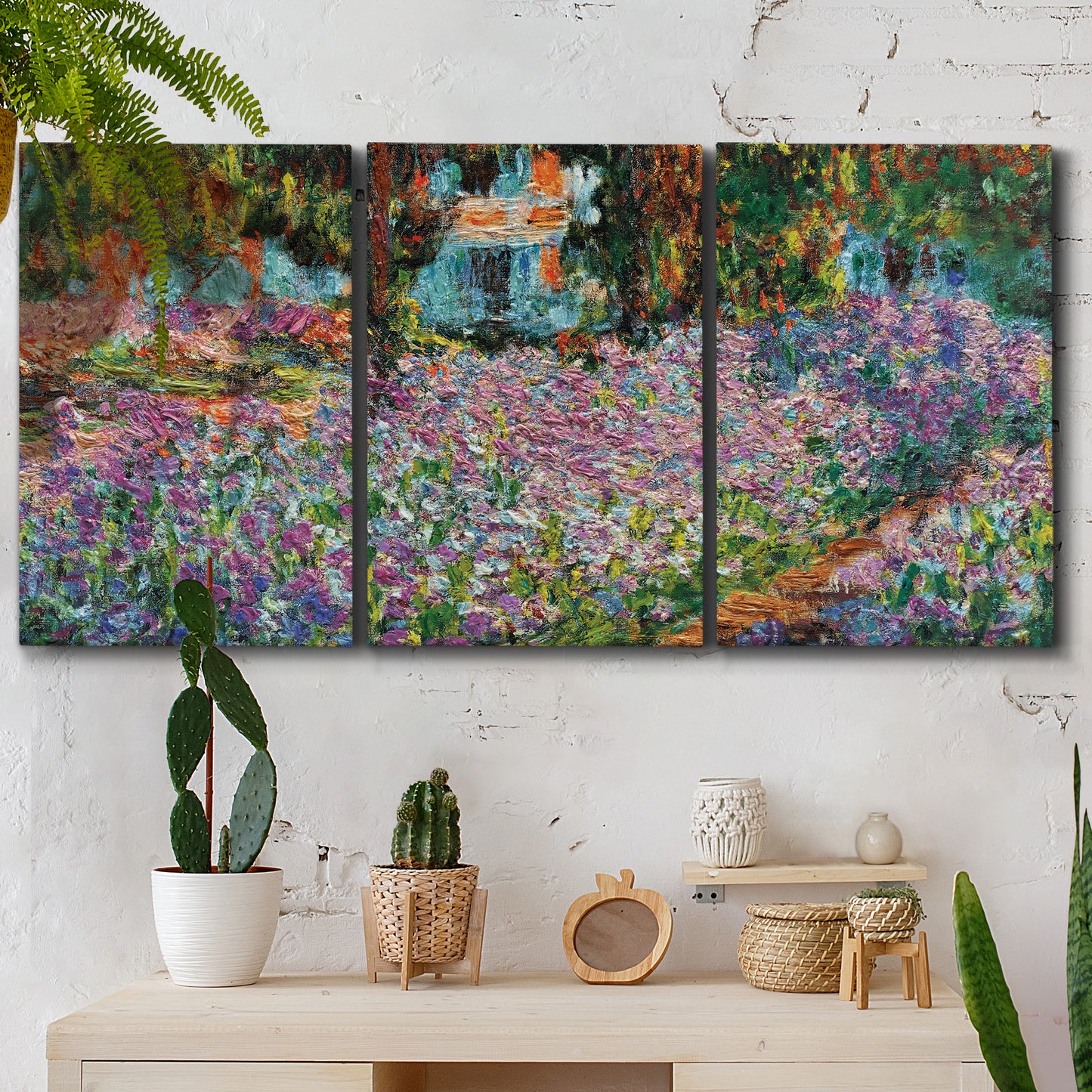 Three-panel canvas wall art featuring blooming irises in garden bed, displayed in a boho-chic entryway above a console table.