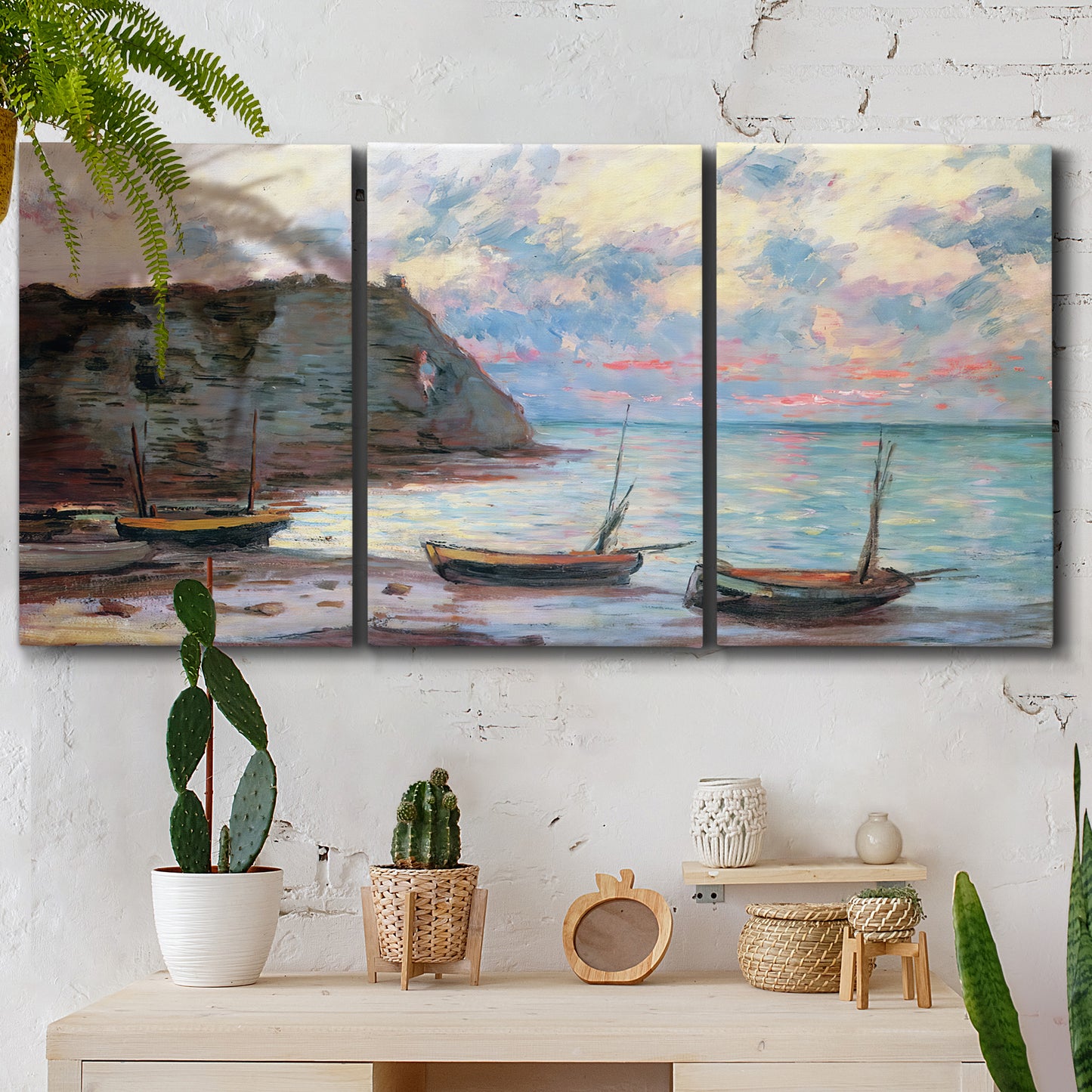 Three-panel canvas wall art featuring golden coastal sunset with cliffs, displayed in a boho-chic entryway above a console table.