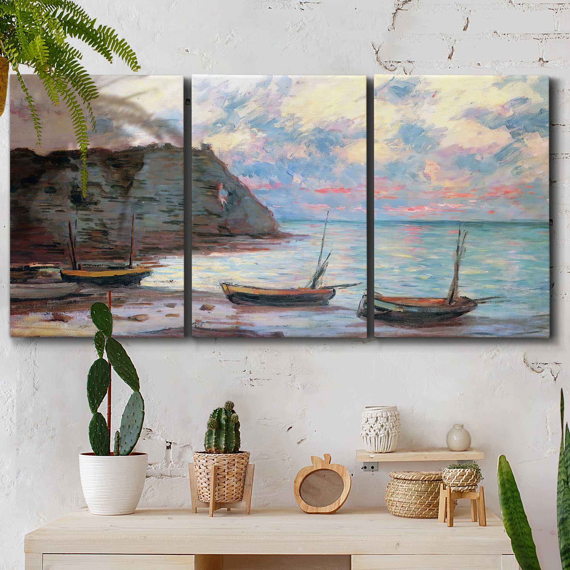 Three-panel canvas wall art featuring golden coastal sunset with cliffs, displayed in a boho-chic entryway above a console table.