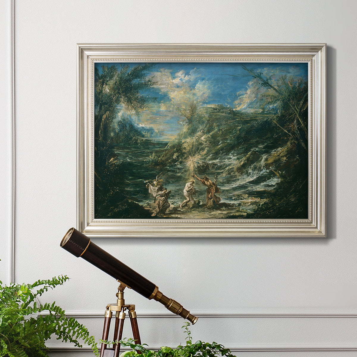 Religious landscape depicting the baptism of Christ by Alessandro Magnasco in an ornate champagne frame displayed in a light-toned interior setting.