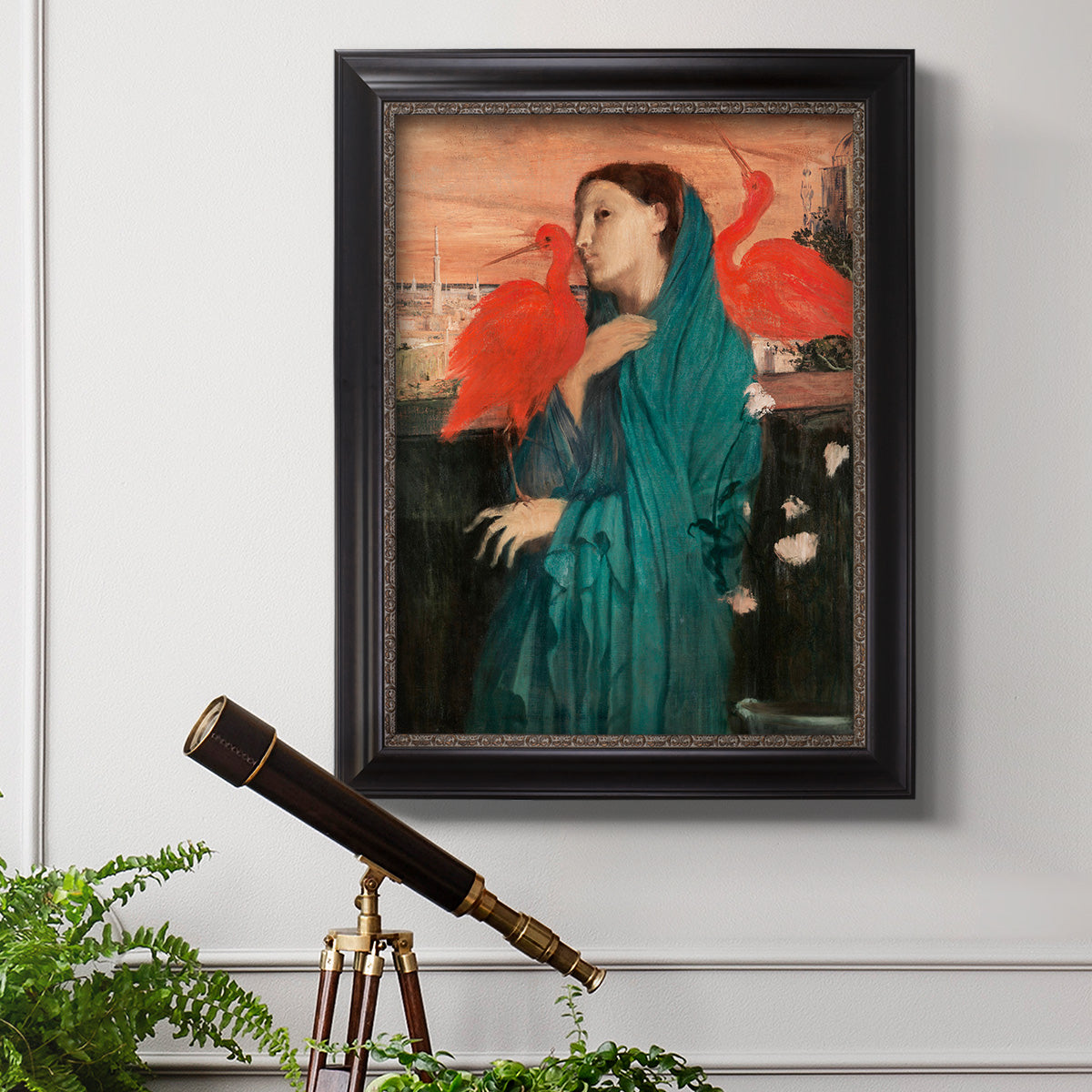 Impressionist portrait of a young woman with an ibis by Edgar Degas in an ornate black frame with gilded inner detail displayed in a light-toned interior setting.