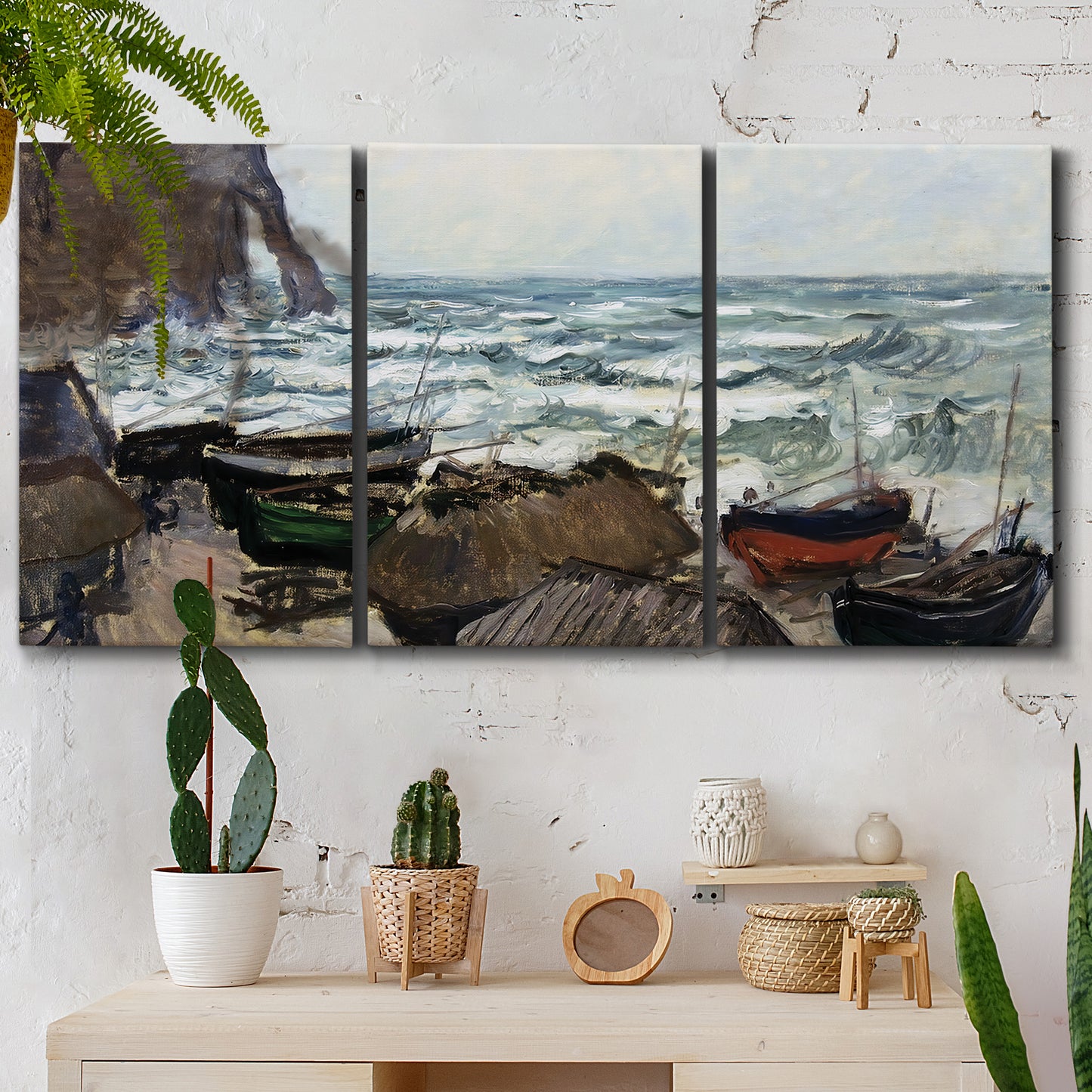 Three-panel canvas wall art featuring rough coastal seas under storm clouds, displayed in a boho-chic entryway above a console table.