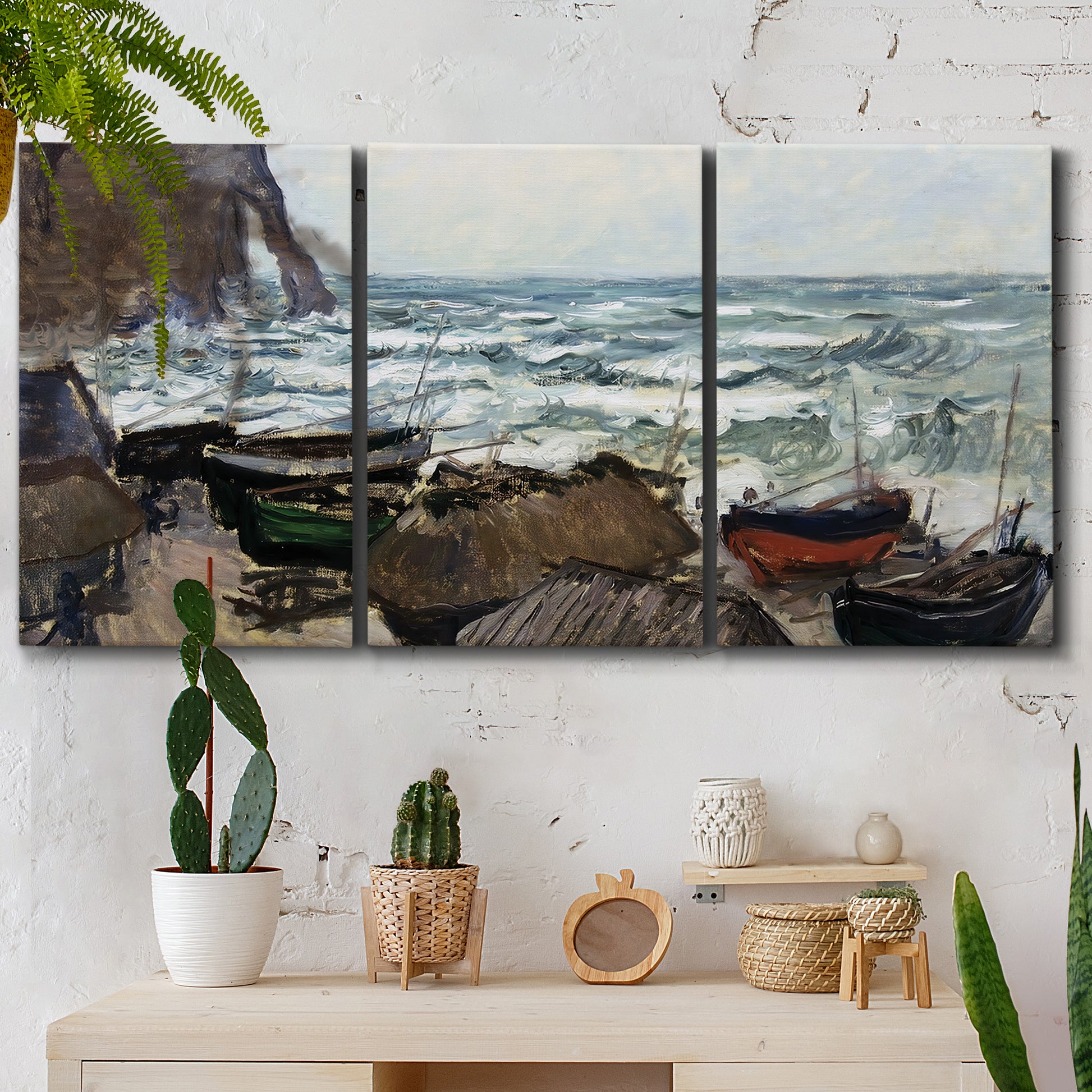 Three-panel canvas wall art featuring rough coastal seas under storm clouds, displayed in a boho-chic entryway above a console table.