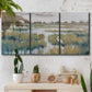 Three-panel canvas wall art featuring pastoral marshland landscape, displayed in a boho-chic entryway above a console table.