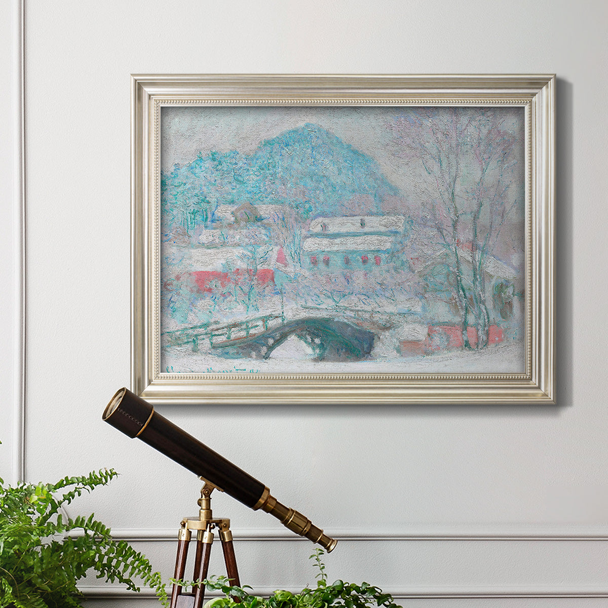 Impressionist coastal village landscape in Norway by Claude Monet in an ornate champagne frame displayed in a light-toned interior setting.