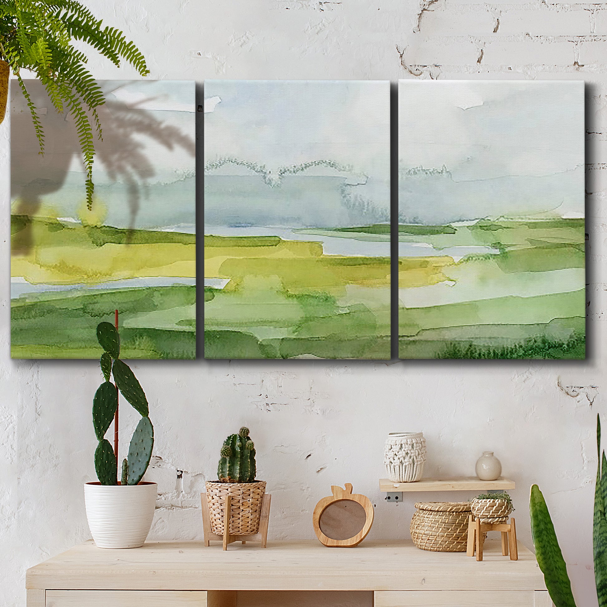 Three-panel canvas wall art featuring lowland wetlands with reflective water, displayed in a boho-chic entryway above a console table.