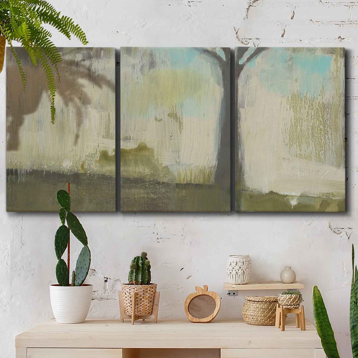 Three-panel canvas wall art featuring tall abstract tree form, displayed in a boho-chic entryway above a console table.