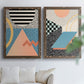 Set of two walnut barnwood framed canvas prints depicting checkerboards stripes squiggles peach blue black and mint shapes arranged across two complementary compositions above a sofa in a bright living space.